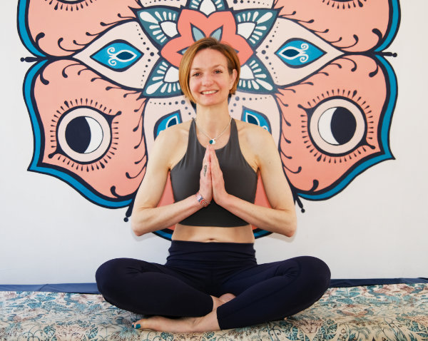 Fiona sat with her hands together leading a wellness event
